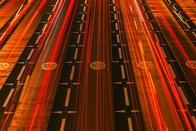 Brake lights streaking over a multi-lane highway by Aleksandar Pasaric.
